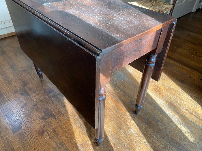 $125 - LOT 1 - Drop leaf table. 38 inches by17.25 inches. 38 inches by 49 inches with leaves up. 29.5 inches tall.