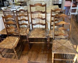 $325- LOT 5 - 6 ladder back chairs with rush seats. 1 arm chair, 5 side chairs.  Side chairs: 39.5 inches high at back, 18 inch high at seats, 18 inches wide front. Arm chair: 45.5 inches high at back, 18 inches high at seat, 22 inches wide at front. 