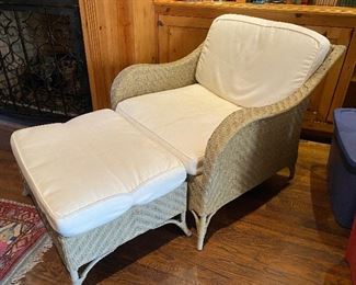 $125 - LOT 6 - White wicker armchair with ottoman. Chair is 31 inches high at back, 35 inches wide. Ottoman is 28 inches wide by 20 inches. 