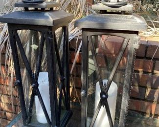 $75 - LOT 21 - 2 metal and glass candle holders, heavy. 22 inches tall, 8 inches square.