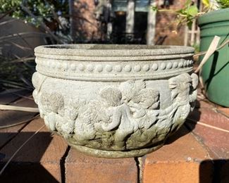 $18 - LOT 22 - cement cache pot with Putti figures. 5 inches tall, 9.5 inches diameter. 