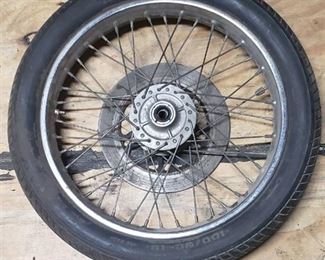 Used CS Hi-Max 100/90-19 57H Front Motorcycle Tire mounted on a spoked chrome rim w/brake plate