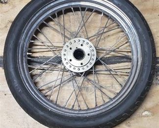 New Dunlop D404F 100/90-19 M/C 57H Front Motorcycle Tire mounted on a spoked chrome rim
