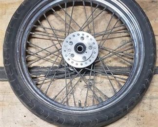Used Bridgestone Spitfire 11F 90/90/19 52H Front Motorcycle Tire mounted on a spoked chrome rim