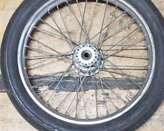 Used Cheng Shin 2.75 - 17 4 ply Front Motorcycle Tire mounted on a spoked chrome rim