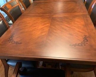 Wood dining table 78 X 48 with 8 leather and wood chairs and 24 inch leaf and table protector pads (matches lot 1001)