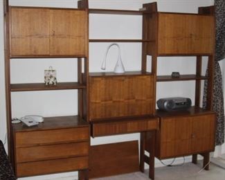 Mid century wall shelves with drop down writing desk, drawers and cabinets.