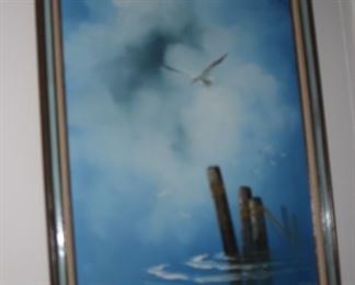 Oil painting of sea gulls flying over water.
