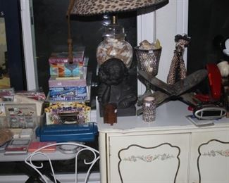 Storage boxes, shredder, packs of napkins, Mickey Mouse phone, shell table lamp.