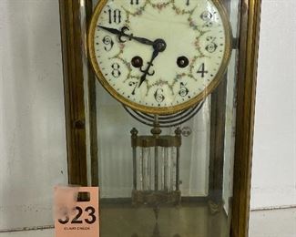 Porcelain faced brass French clock with lead weighted pendulum 