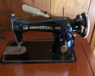 Antique Universal sewing machine in cabinet.  Very good cosmetic appearance