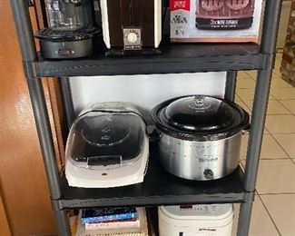 Small kitchen appliances and cookbooks, magazines, and dieting books. Bread maker, crock pot George Forman grills, toaster, and espresso maker. 