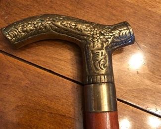 Wooden cane with ornate brass handle