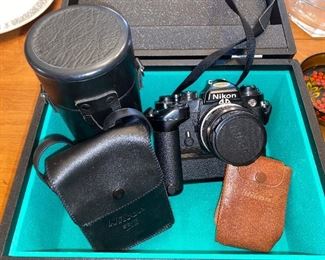 Nikon FE camera. Complete with 2 lenses, 2 external flashes, a motor drive, and carrying case. 