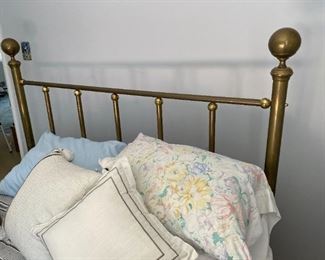 Twin brass bed.