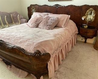 PRICE - $1,800; Early 1900s antique French queen bed; burl mahogany; headboard outfitted with side tables, mirrors and electrical outlets for lighting; headboard is 117" wide; footboard is 70" wide (88" from headboard to footboard).