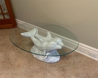 Wood base dolphin cocktail table with oval glass top 

44.5”x 34 3/4”