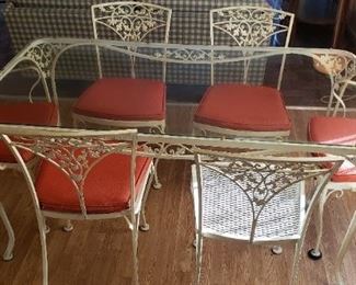 Vintage 7pc Wrought Iron Dining Set with Glass Top Table. Includes table, 4 chairs, 2 captain's chairs. Table dimensions: 60"L x 33"W x 29"H. Available for pre-sale. For more information, please contact us at contactmvp@moorevaluepros.com
