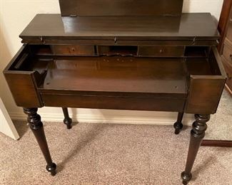 UNIQUE ANTIQUE DESK WITH INK WELL AND SECRET COMPARTMENTS.