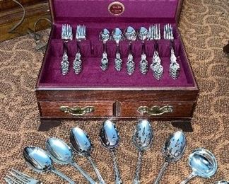 12 5 pc place settings  Gorham Momento ornate Stainless flatware plus 12 serving pieces. 72 pc total 
Includes silver storage chest
We have two sets plus another set of 8 so 32 place settings total. 