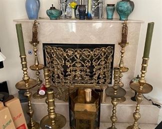 Candle stands and ornate fireplace screen. 