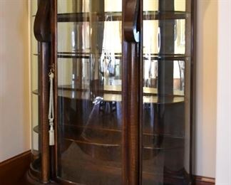Beautiful lion foot display cabinet with curved glass panes.
