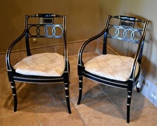 Lacquered and gilt chairs with custom cushions atop caned seats. 