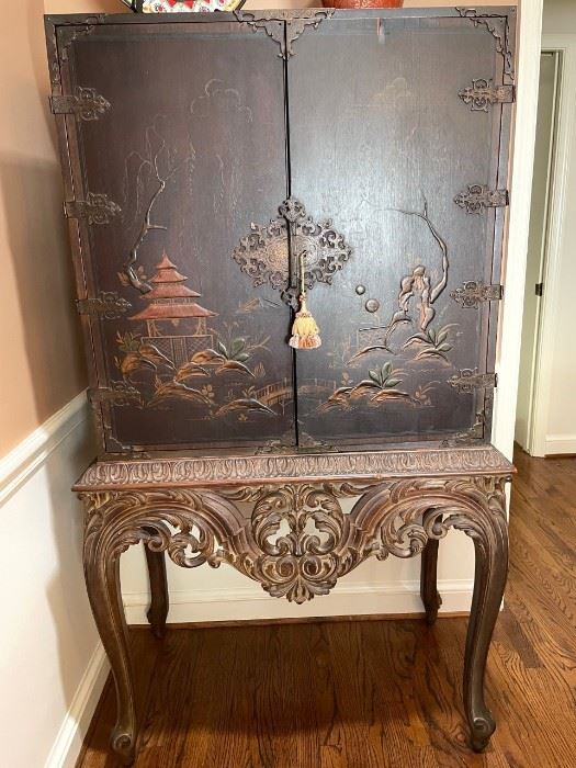 $1200  -  Chinese Chinoiserie Drinks Cabinet with Gold Giltwood Carved Base

LOCATION:  Washington DC

WHY WE LOVE IT:

Lovely vintage Chinese chinoiserie hardwood drinks cabinet with gold giltwood base. A good looking and decorative piece, made as a drink’s cabinet likely in the 19th century in the Chinese Chippendale taste. The insides of the doors have additional artwork which are works of art on their own. This piece is in very good order throughout, there will be natural patina throughout the piece to be expected with use and age. 

DETAILS + DIMENSIONS:  37.5"W x 21"D x 66"H

CONDITION: This is a vintage piece and in good vintage condition.  There are signs of natural patina and signs of wear to be expected with use and age. Please refer to photos for a more detailed look at condition.  We make every attempt to list and photograph any defects or signs of wear that are significant to this sale. 

LOCAL PICK UP WASHINGTON, D.C.   BUYER IS RESPONSIBLE FOR ANY NECESSARY DISASSEMBLY A