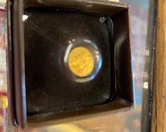 Tiny gold replica coin