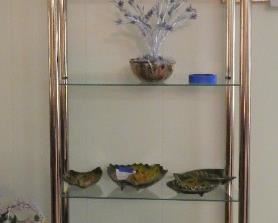 One of two brass and glass 5-shelf units
