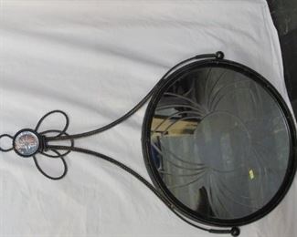 Black metal mirror with design on mirror