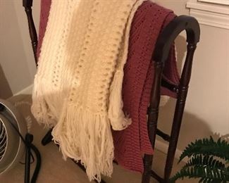 Oak quilt stand with many throw blankets and quilts!