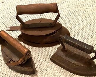 Three antique cast iron flat irons. Also have three asbestos sad irons