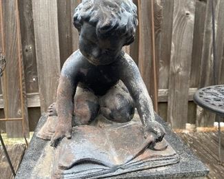 Concrete statue, little boy reading