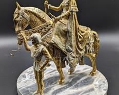 Fantastic Brass and Marble Sculpture featuring a regal female rider accompanied by a figurine leading her horse.

It looks like one of the reins on the front of the horse is loose. Marked made in Spain. Measures about 12” high and the base is 9.5” in diameter.