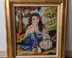 Framed Vintage Needlepoint Tapestry in a beautiful gold frame featuring a charming young lady.  Measures 29” x 33”.