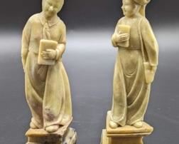Pair of Carved Soapstone Figurines. The figurine on the left looks to have a hairline crack that can be seen in the photos. Each measures about 8” high.
