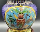 This Cloisonné lidded vessel measures 9.5 inches tall and comes with a wooden vase.