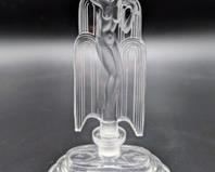 Czech Art Deco Perfume Bottle. Truly a lovely and beautiful design featuring a nude figurine.

Measures 7” high and 4” wide at the base.