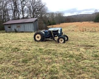 Ford tractor with grader underneath