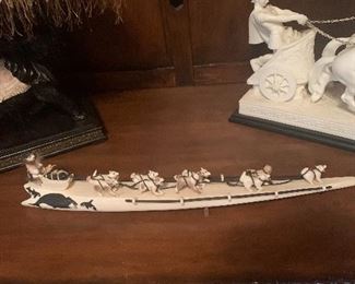 Hand carved ivory task carved into sled dogs with sled