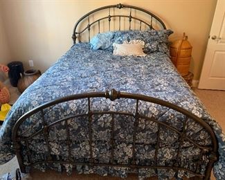 This is a queen size iron bed with mattress and box springs