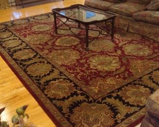 Living Room:  The area rug in deep burgundy/black/gold  measures 10' x 14.' 