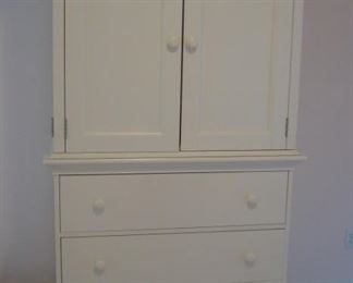 Bedroom #3-Upstairs:  A white CRATE & BARREL armoire has two upper doors over three drawers.  It measures 41" wide x 24" deep x 76" tall.