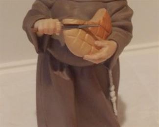 "Smalls" Area:  This very collectible matte porcelain monk figure is slicing the bread.  It is by ALGORA.