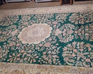 Lower Level:  We unrolled this rug as it had been in storage.  A floral pattern is on a green center surrounded by a lighter border.  It measures 7'  8"  x  10"  4." 