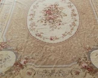 Lower Level:  This classic AUBUSSON needlepoint rug in subtle colors of tan, cream and rose measures 8'  8"  x  11'  9."
