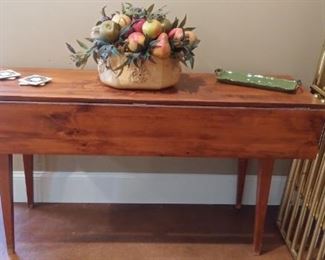 Lower Level:  A narrow drop leaf table measures 60" x 20" with the leaves down but 60" x 38" with both leaves up.  The faux fruit arrangement in a ceramic bowl and other decor are also for sale.