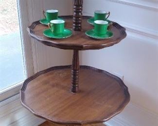 Dining Room:  A three-tier vintage dumb waiter displays a green/white porcelain vase and a set of four green/white demitasse cups.  Dumb waiters were popular from the 1700's through to the 1930's.  They were used to store food that was about to be served.  However, when the ladies retired, the staff would move the dumb waiters to the ends of the table and place alcoholic beverage on them for the men.  The staff would then leave for the evening and the men could speak freely about many topics without the staff hearing them, hence the name "dumb waiter."  