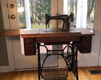 Kitchen Area: An antique SINGER sewing machine and its accessories are included with this two-drawer oak cabinet. 